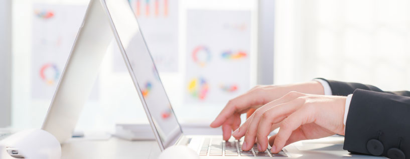 Hands typing on laptop computer